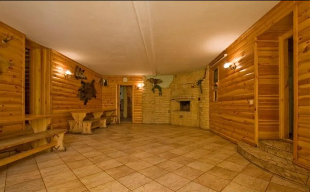 A wood-fired sauna with a pool by the pond